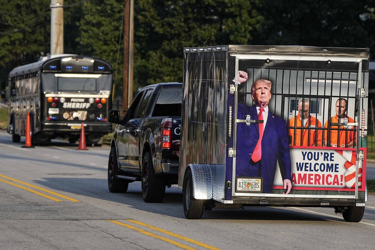 A vehicle and trailer drive by the Fulton County Jail, Thursday, Aug. 24, 2023, in Atlanta. Trump is charged alongside others, who are accused by Fulton County District Attorney Fani Willis of schemin ...