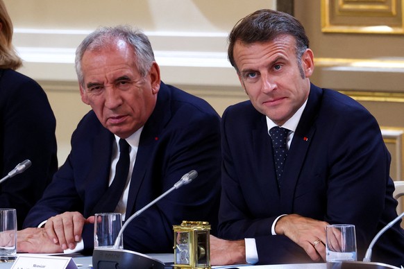 epa12234325 French Prime Minister Francois Bayrou (L) and French President Emmanuel Macron (R) attend a meeting with New Caledonia&#039;s elected officials and state representatives at the Elysee Pala ...