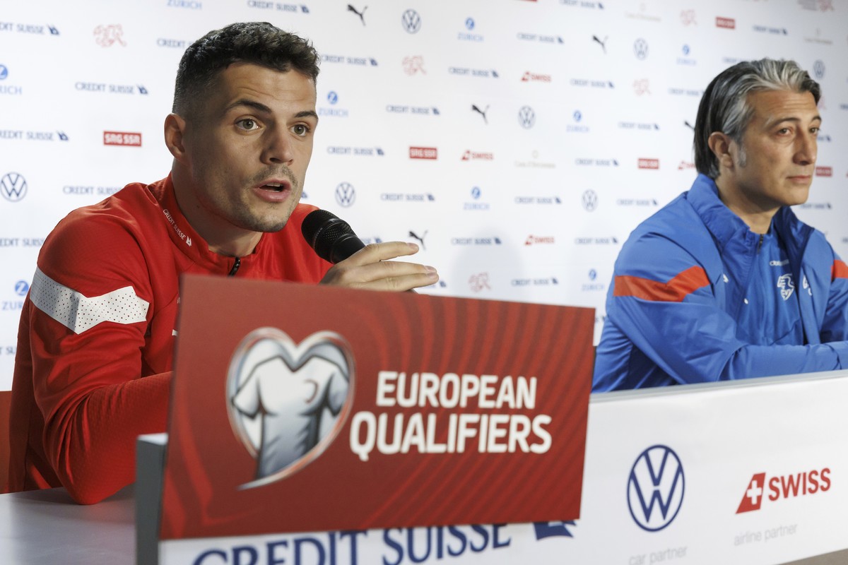 Switzerland's coach Murat Yakin, right, and Switzerland's midfielder Granit Xhaka, take part in a press conference a day prior to the Euro 2024 qualifying group I soccer match between Switze ...