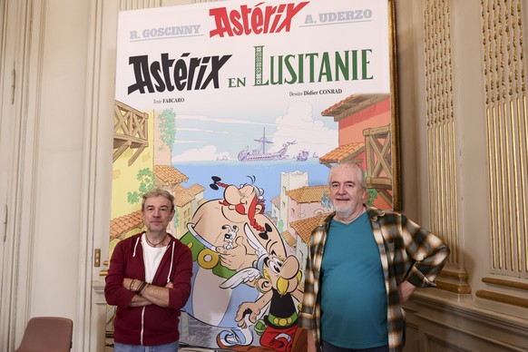 epa12450010 French novelist Fabcaro (L) and French Cartoonist Didier Conrad (R) pose during the presentation of the comic book &#039;Asterix in Lusitania&#039; at the Portuguese Embassy in Paris, Fran ...