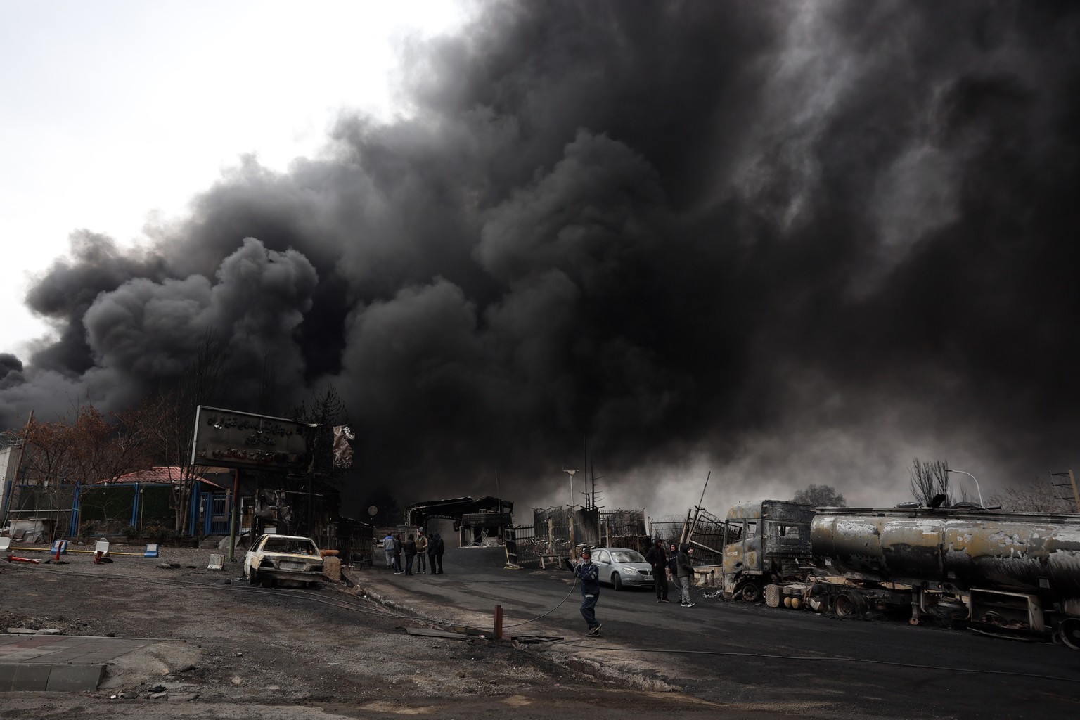 KEYPIX - epa12804499 A view of the Main gate to the Shahran Oil Refinery as smoke still rises following last night airstrike in Tehran, Iran, 08 March 2026. A joint Israeli and US military operation c ...