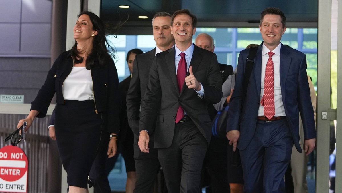 Davida Brook, left, Justin Nelson, center, and Stephen Shackelford, right, attorneys for Dominion Voting Systems, exit the New Castle County Courthouse in Wilmington, Del., after the defamation lawsui ...