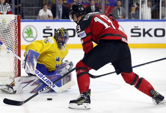 Sweden&#039;s goalie Henrik Lundqvist makes a save in front of Canada&#039;s Mike Matheson during the Ice Hockey World Championships final match between Canada and Sweden in the LANXESS arena in Colog ...