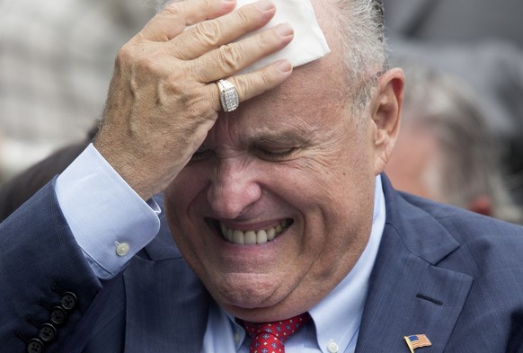 epa06774507 Attorney to US President Donald J. Trump Rudy Giuliani wipes his brow before the start of the White House Sports and Fitness Day at the South Lawn of the White House in Washington, DC, USA ...