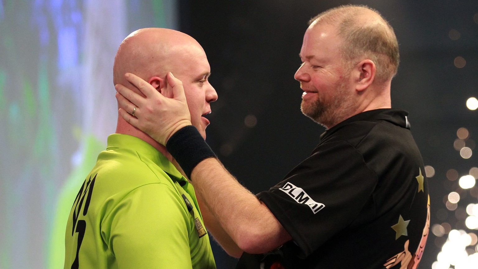 epa05694702 Michael van Gerwen (L) is congratulated by Raymond van Barneveld after his 6-2 win inthe PDC World Darts Semi final between Michael van Gerwen and Raymond van Barneveld at the Alexander Pa ...