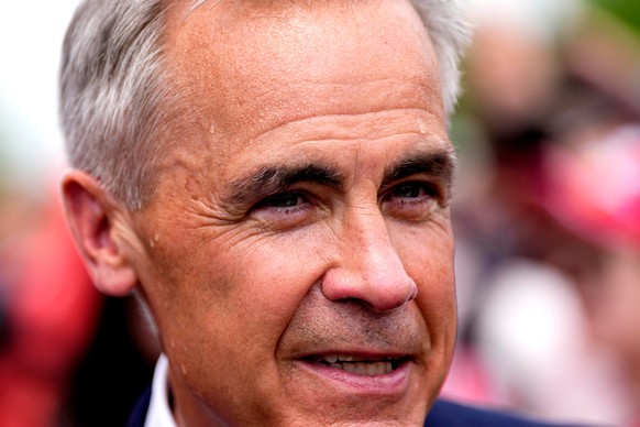 Sweat beads on the face of Canada Prime Minister Mark Carney as he attends the Canada Day National noon ceremony at LeBreton Flats in Ottawa amid a heat warning, on Wednesday, July 1, 2026. (Justin Ta ...