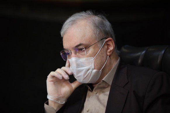 epa08321619 A handout photo made available by the Iranian President office shows Iran&#039;s Health Minister Saeed Namaki wears face mask during cabinet meeting , in Tehran, Iran, 25 March 2020. Media ...