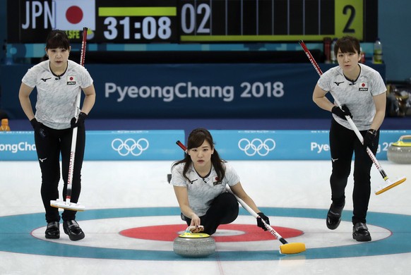 Japan&#039;s Chinami Yoshida, center, prepares to throw the stone during their women&#039;s curling match against Denmark at the 2018 Winter Olympics in Gangneung, South Korea, Thursday, Feb. 15, 2018 ...