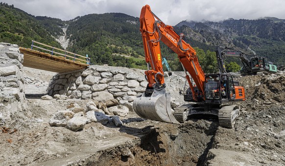 Une pelleteuse travaille dans la zone autour du pont fusible sur le torrent du Fregnoley emporte a la suite d&#039;une serie de laves torrentielles durant le mois de juillet, le lundi 26 aout 2024 ent ...