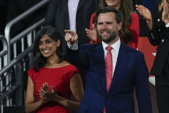 Republican vice presidential candidate Sen. JD Vance, R-Ohio, gestures to Republican presidential candidate former President Donald Trump during the Republican National Convention Thursday, July 18, 2 ...