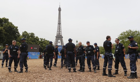 epa05355072 Municipal police officers gather inside the UEFA EURO 2016 Fan Zone, near the Eiffel tower in Paris, France, 10 June 2016. The UEFA EURO 2016 soccer tournament kicks off on 10 June with th ...