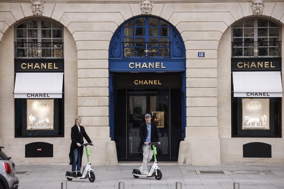 epa10553715 People ride self-service scooters in Paris, France, April 1, 2023. On April 2, residents of Paris will be able to vote whether to ban self-service scooters in the city.  EPA/YOAN VALA...