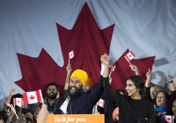 NDP leader Jagmeet Singh and his wife Gurkiran Kaur Sidhu reacts on stage to supporters at his election night headquarters in Burnaby, B.C., on Tuesday, Oct. 22, 2019. (Nathan Denette/The Canadian Pre ...