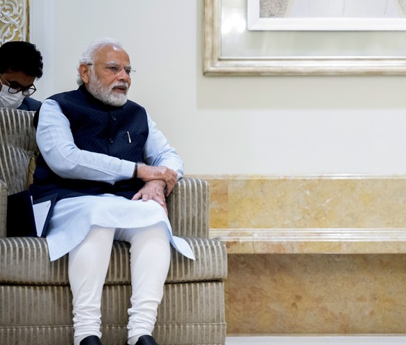 In this photo made available by Ministry of Presidential Affairs, President of the United Arab Emirates Sheikh Mohamed bin Zayed Al Nahyan, right, receives the Prime Minister of India Narendra Modi at ...