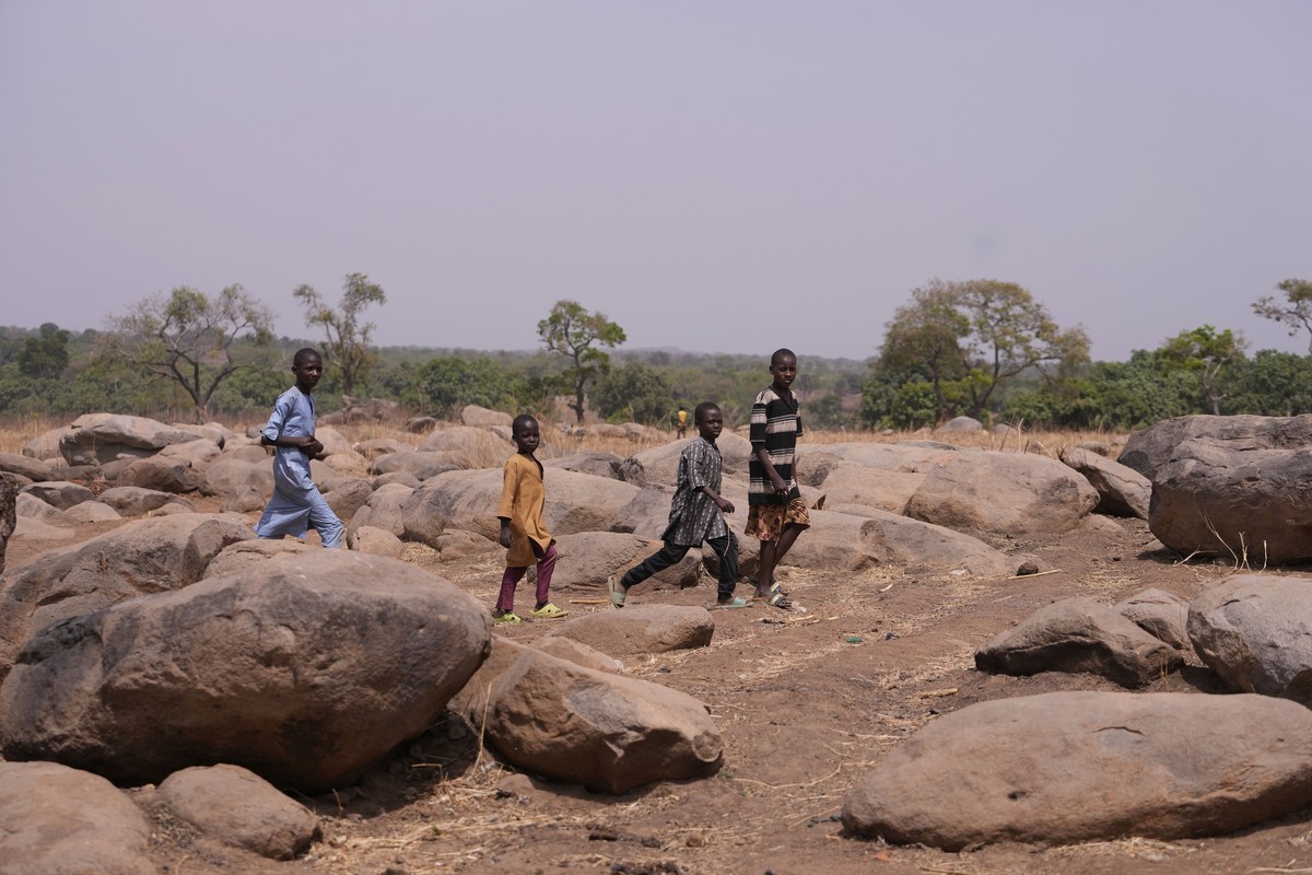 Children walk past the bush paths that the abducted schoolchildren of the LEA Primary and Secondary School followed in Kuriga, Kaduna Nigeria, Saturday March. 9, 2024. The kidnapping on Thursday was o ...