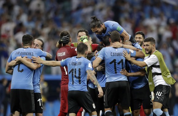 Uruguay players celebrate after defeating Portugal in the round of 16 match between Uruguay and Portugal at the 2018 soccer World Cup at the Fisht Stadium in Sochi, Russia, Saturday, June 30, 2018. (A ...
