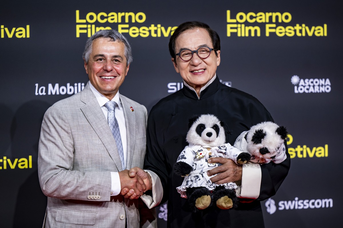 Hong Kong actor Jackie Chan poses on the red carpet next to Ignazio Cassis, left, Swiss Federal Councilor and Head of the Federal Department of Foreign Affairs during the 78th Locarno International Fi ...