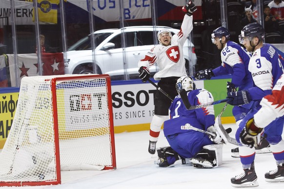 Switzerland&#039;s forward Tristan Scherwey, left, celebrates his goal past Slovakia&#039;s goaltender Marek Ciliak, Slovakia&#039;s defender Christian Jaros #62, and Slovakia&#039;s defender Adam Jan ...