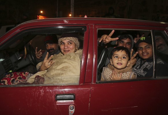 Pakistan family celebrate the new year in downtown of Lahore, Pakistan, Wednesday, Jan. 1, 2020. (AP Photo/K.M. Chaudary)