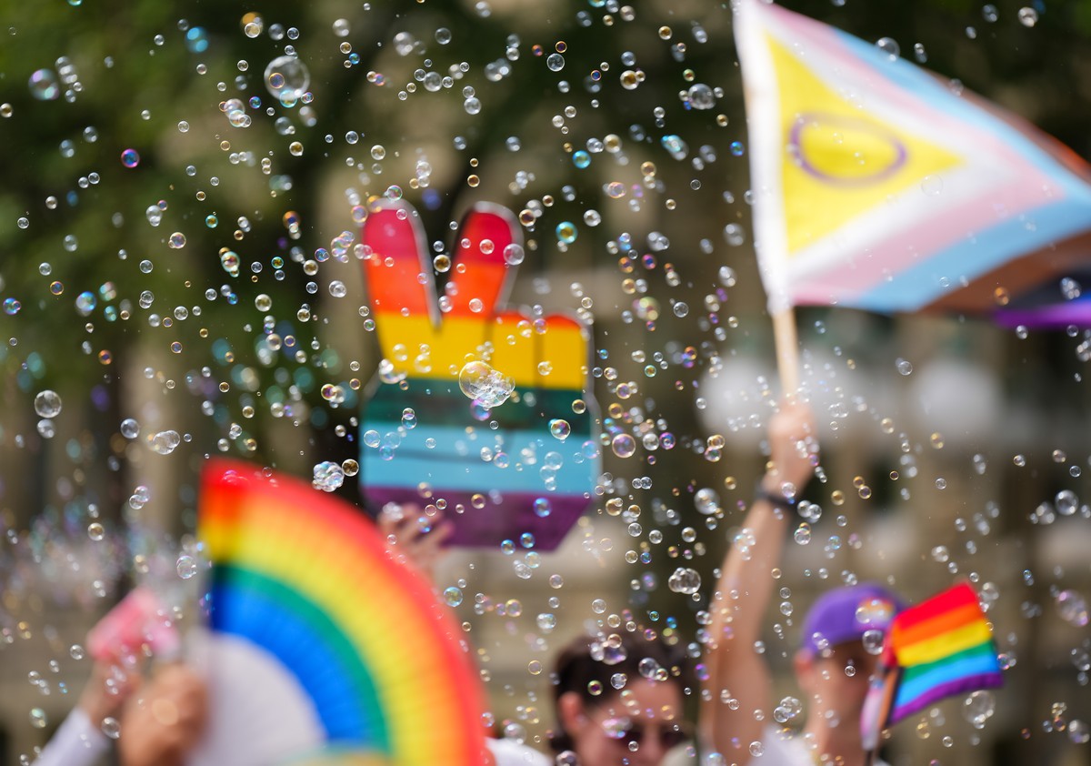 Bubbles fly through the air as a person waves a peace sign in the colours of the rainbow during the Capital Pride Parade, in Ottawa, Canada, Sunday, Aug. 30, 2026. (Chris Tanouye/The Canadian Press vi ...