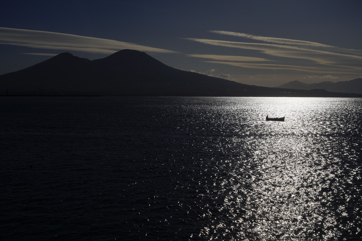 A boat sails past Vesuvius in Naples, Italy,Thursday, March 16, 2023. (AP Photo/Gregorio Borgia)