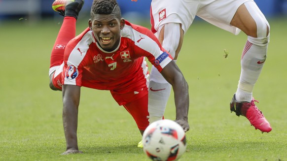 Switzerland&#039;s Breel Embolo falls in front of Poland&#039;s Grzegorz Krychowiak during the Euro 2016 round of 16 soccer match between Switzerland and Poland, at the Geoffroy Guichard stadium in Sa ...