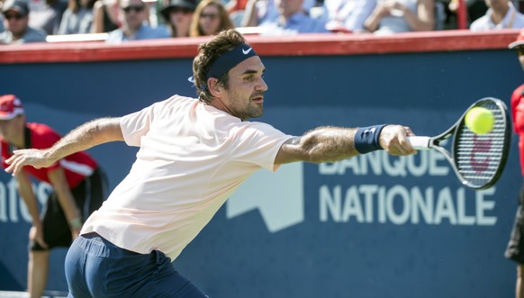 Roger Federer, of Switzerland, returns the ball to Robin Haase, of the Netherlands, during Rogers Cup tennis action in Montreal on Saturday, Aug. 12, 2017. (Paul Chiasson/The Canadian Press via AP)