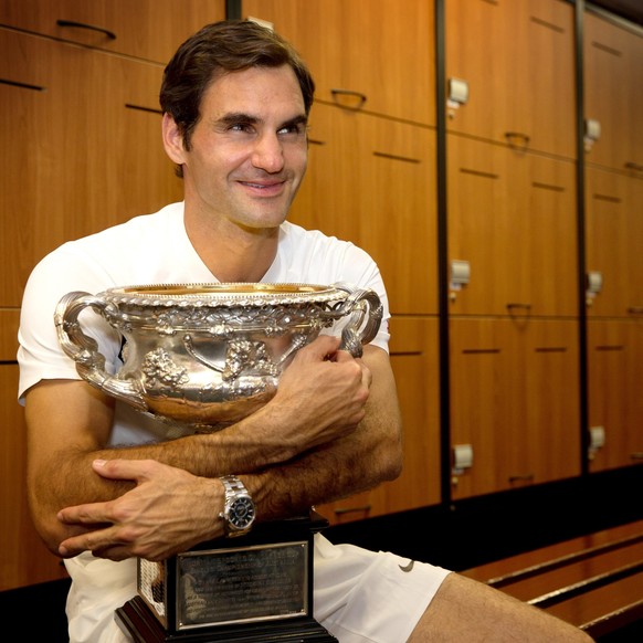 epa06481356 A handout photo made available by Tennis Australia shows Roger Federer of Switzerland posing with his trophy in the men&#039;s locker room after winning the men&#039;s final match against  ...