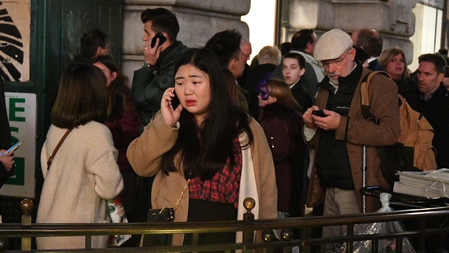 epa06348654 Pedestrians react to an incident near Oxford Circus tube station in Oxford Street, central London, Britain. 24 November 2017. The London Metropolitan Police (MPS) state that Police officer ...