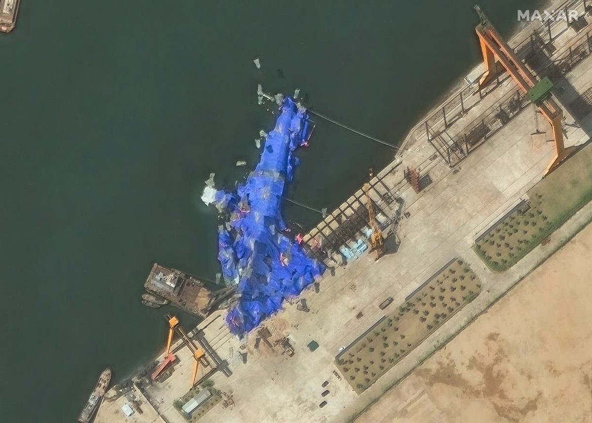 epa12128706 A handout satellite image made available by Maxar Technologies shows a new North Korean warship at the harbour after its launch accident in Chongjin, North Korea, 23 May 2025. North Korean ...