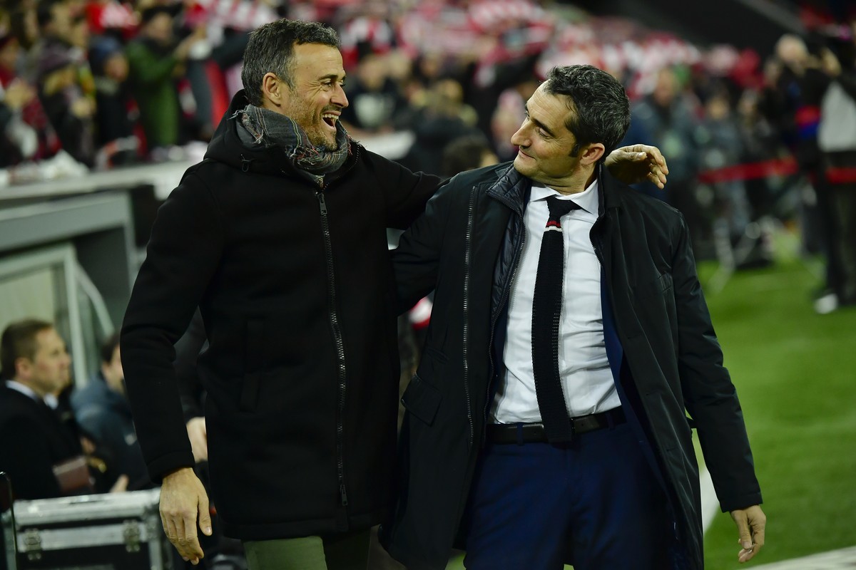 FILE- In this Thursday, Jan.5, 2017 file photo, Barcelona's manager Luis Enrique, left smiles beside Athletic Bilbao's manager Ernesto Valverde, during the Spanish Copa del Rey, 16 round, fi ...