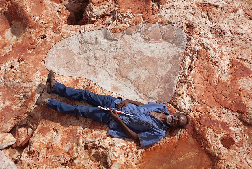 A supplied image of Aboriginal elder and Goolarabooloo Law Boss Richard Hunter alongside a 1.75m sauropod dinosaur track in the Lower Cretaceous Broome Sandstone, Walmadany area, Dampier Peninsula, in ...