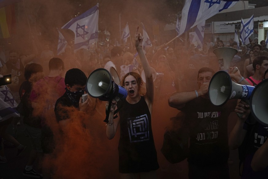 Demonstrators shout slogans during a protest against plans by Prime Minister Benjamin Netanyahu&#039;s government to overhaul the judicial system, in Tel Aviv, Israel, Thursday, July 20, 2023. (AP Pho ...