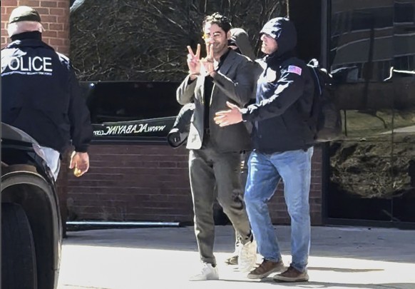 This image taken from a video provided by Christopher Helali shows Mohsen Mahdawi, a Palestinian man who led protests against the war in Gaza as a student at Columbia University, being detained at the ...