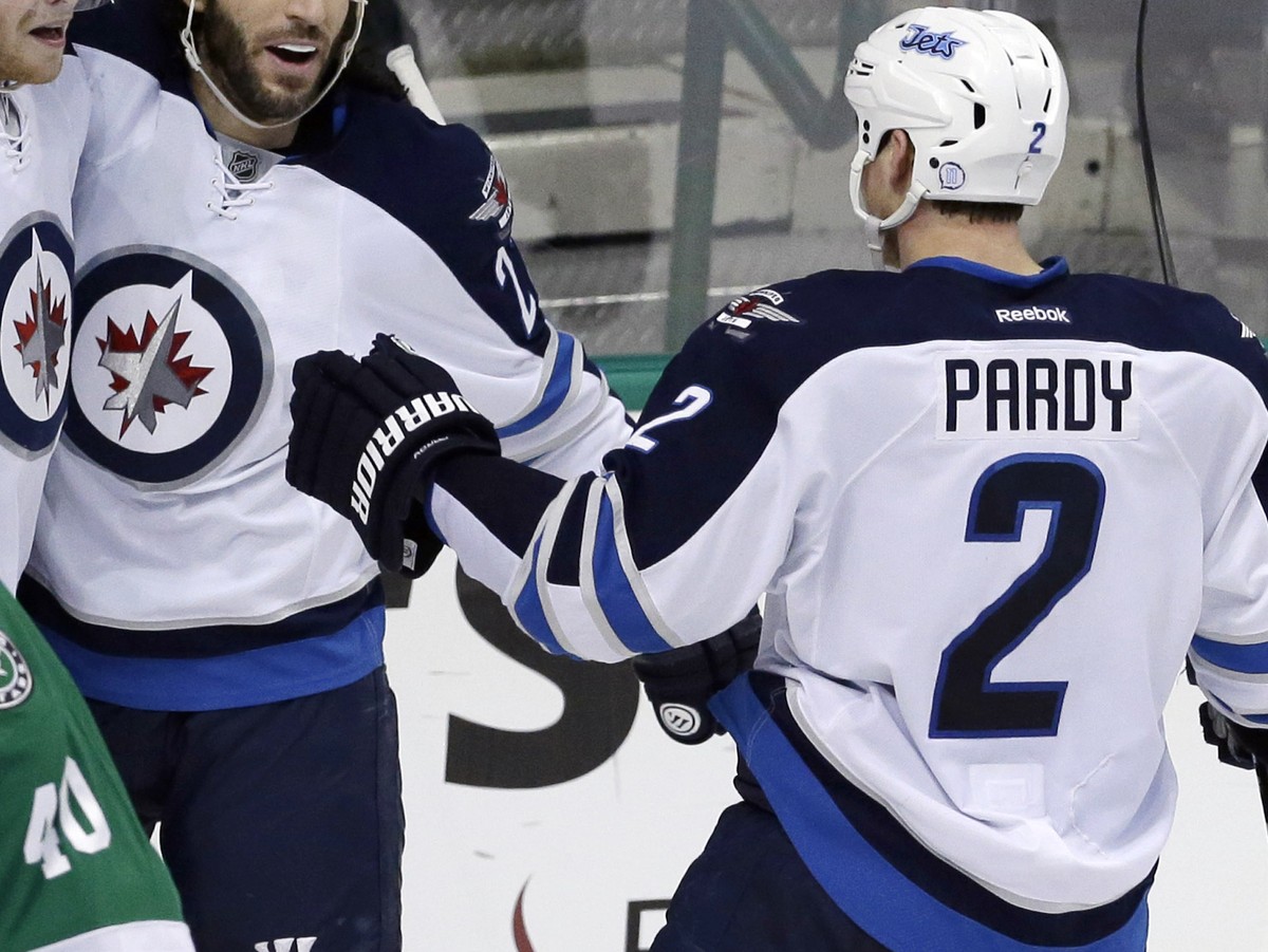 Winnipeg Jets left wing Adam Lowry (17) celebrates his goal with teammates Chris Thorburn (22) and Adam Pardy (2) as Dallas Stars goalie Jussi Rynnas (40) skates off during the second period of an NHL ...