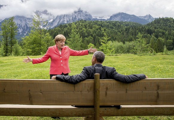 FILE - In this Monday, June 8, 2015 file photo, German Chancellor Angela Merkel speaks with U.S. President Barack Obama at Schloss Elmau hotel near Garmisch-Partenkirchen, Germany, during the G-7 summ ...