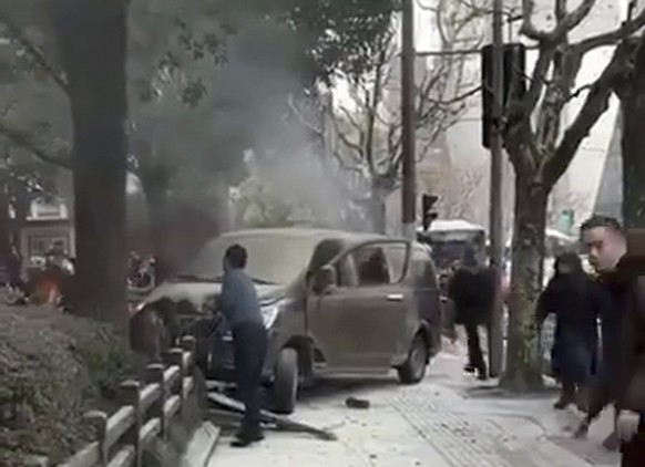 In this image taken from cellphone video provided to the Associated Press, a minivan involved in an accident rests on the sidewalk along a street in Shanghai, Friday, Feb. 2, 2018. A minivan plowed in ...