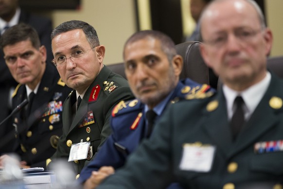 Turkish Lt. Gen. Erdal Ozturk, second from left, and others, listen as President Barack Obama speaks during a meeting with more than 20 foreign defense ministers on the ongoing operations against the  ...