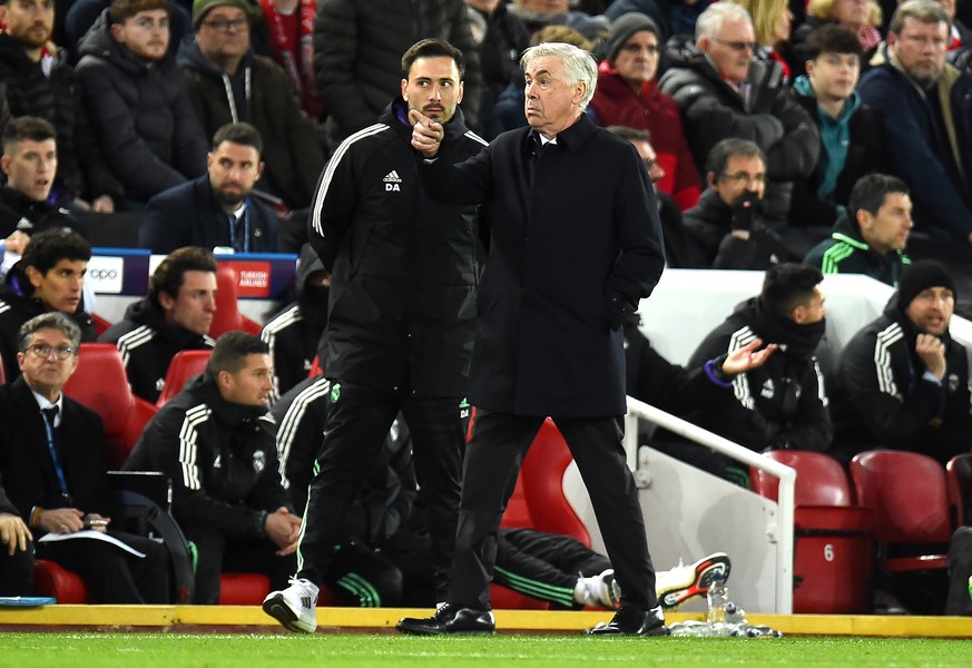 epa10482710 Real Madrid head coach Carlo Ancelotti (R) talks to his son and assistant coach Davide Ancelotti during the UEFA Champions League, Round of 16, 1st leg match between Liverpool FC and Real  ...