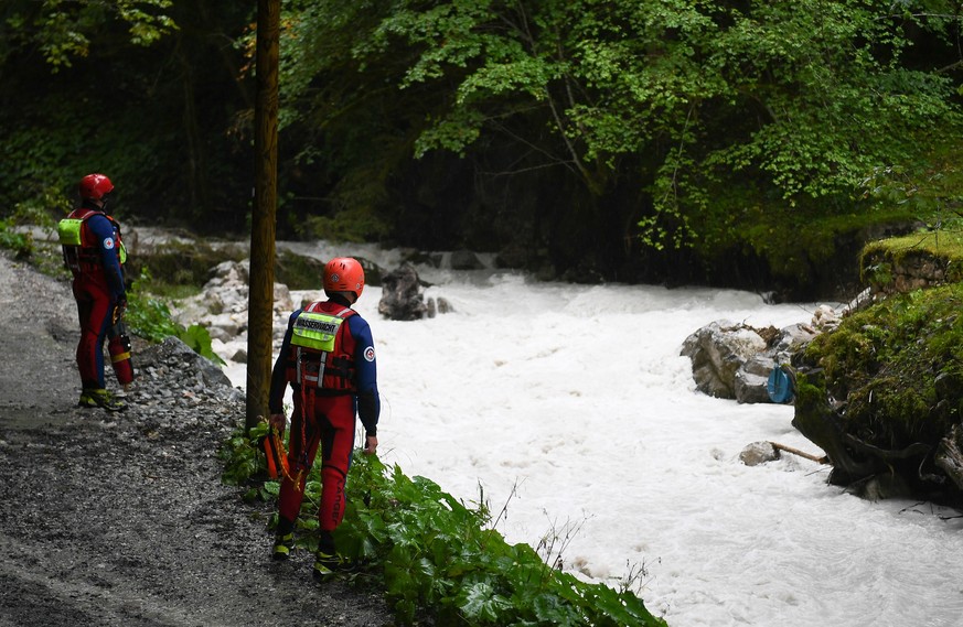 epa09416680 Rescue workers look out for victims of a floodwave at the Hammersbach creek near Garmisch-Partenkirchen, Germany, 16 August 2021. After heavy rainfalls, a sudden floodwave hit the Hoellent ...
