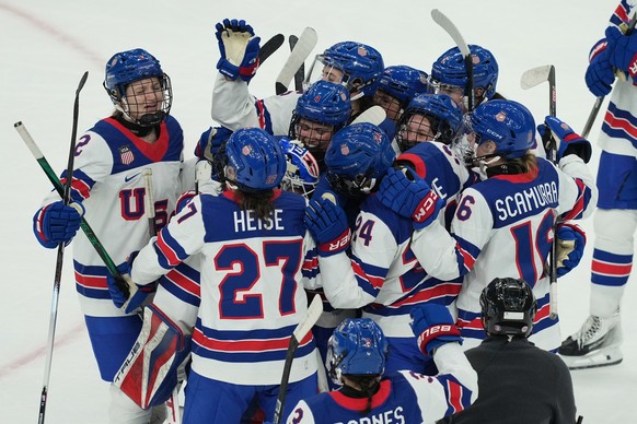 US players celebrate at the end of a preliminary round match of women's ice hockey between USA and Canada at the 2026 Winter Olympics, in Milan, Italy, Tuesday, Feb. 10, 2026. (AP Photo/Antonio C ...