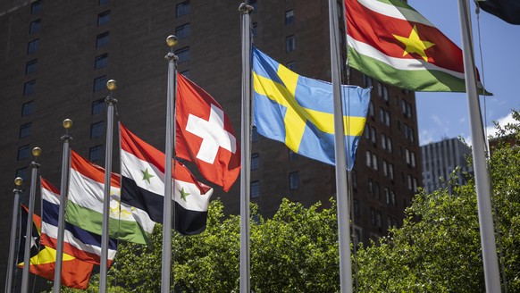 FILE - The Swiss flag, left, flies with the flags of the other member states after Switzerland&#039;s election with four other countries as non permanent members to the Security Council for the period ...