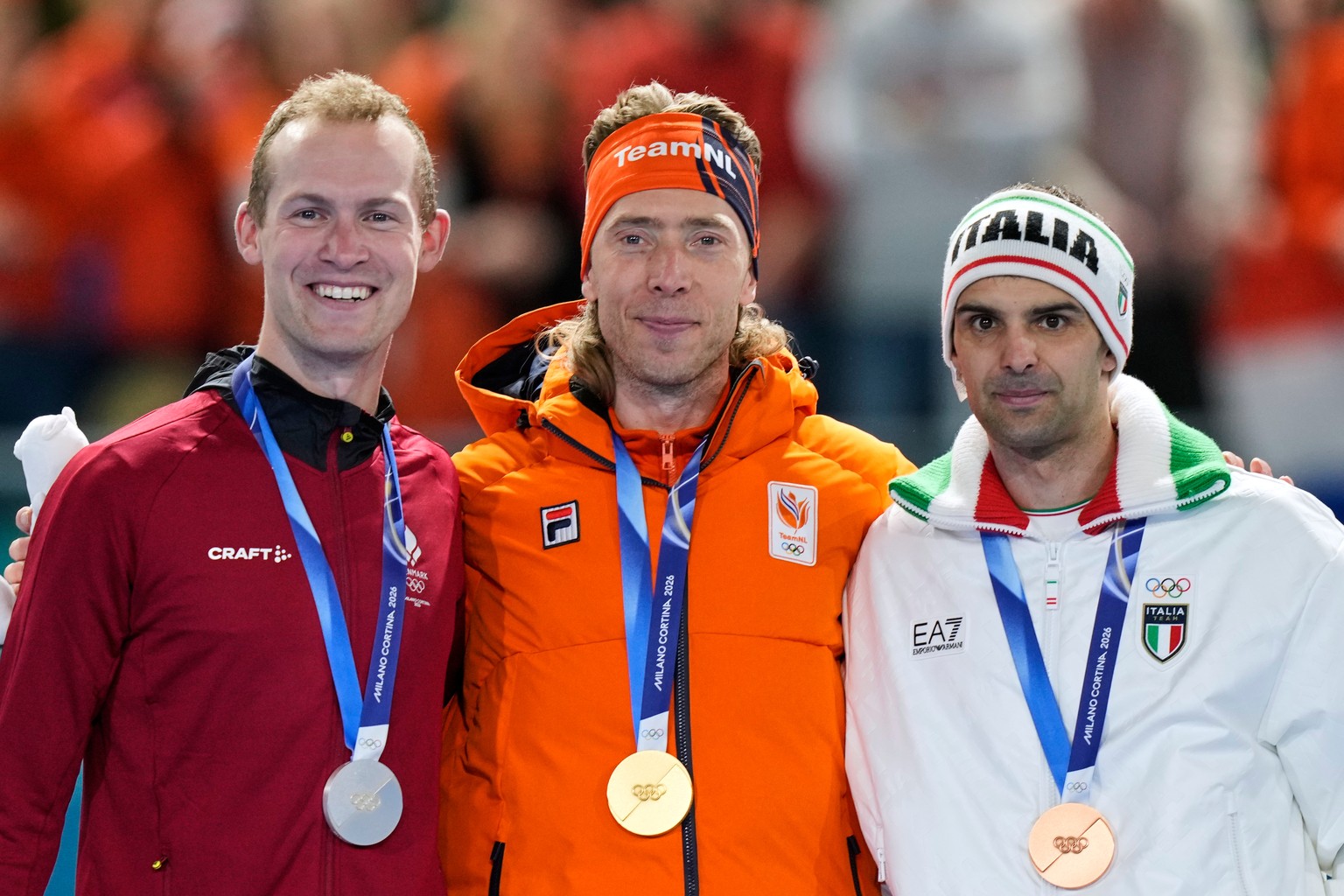 Jorrit Bergsma of the Netherlands, center and gold medal, Viktor Hald Thorup of Denmark, left and silver medal, and Andrea Giovannini of Italy, right and bronze medal, celebrate on the podium of the m ...