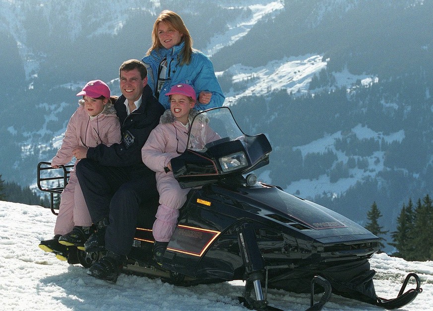 Britain&#039;s Prince Andrew and his ex-wife, Duchess of York Sarah Ferguson, pose with their two daughters Eugenie (left) and Beatrice, on a snowbike, in the ski ressort of Verbier, Switzerland, on F ...