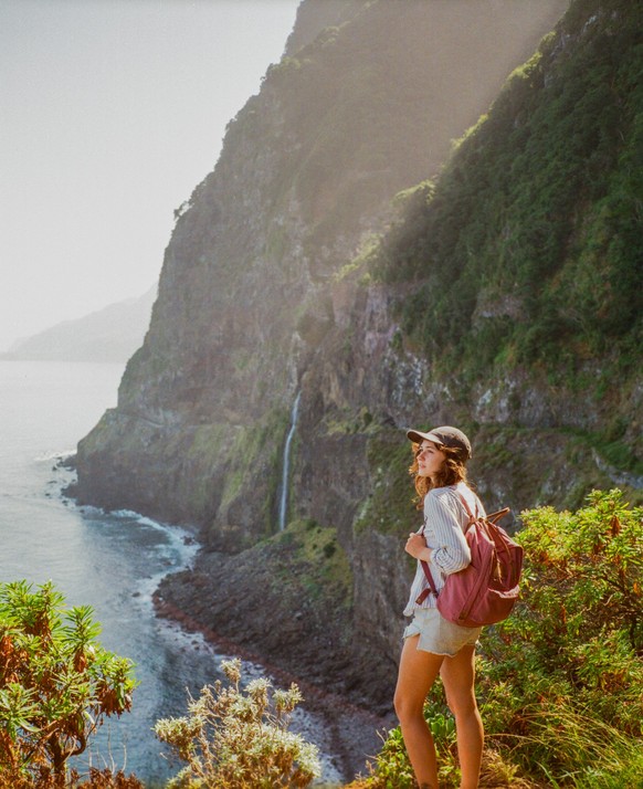 Woman exploring epic views of Madeira island and hiking, shot on camera film with vintage feel