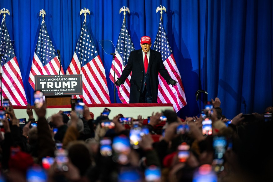 epa11162563 Former President Donald J. Trump speaks during a Get Out the Vote Rally and campaign event at the Elite Jet Center in Waterford Township, Michigan, USA, 17 February 2024. Trump is running  ...