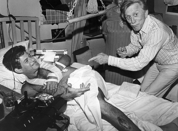 American movie star Kirk Douglas jokes with an Israeli soldier, who was wounded in Lebanon, in the Hadassah Hospital, in Jerusalem, on Aug. 8, 1982. The American actor is on a few days visit to Israel ...