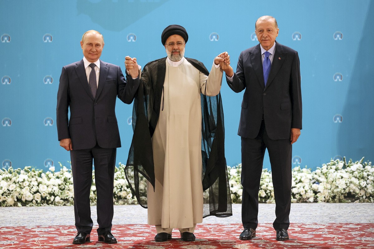 Russian President Vladimir Putin, from left, Iranian President Ebrahim Raisi and Turkish President Recep Tayyip Erdogan, pose for a photo prior to their talks at the Saadabad palace, in Tehran, Iran,T ...