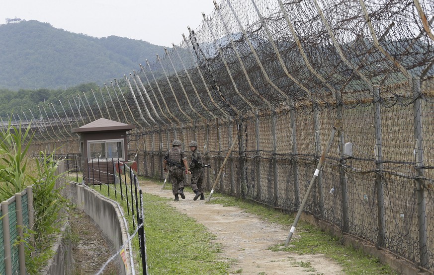 FILE - South Korean soldiers patrol as hikers visit the DMZ Peace Trail in the Demilitarized Zone in Goseong, South Korea, June 14, 2019. A series of low-rise buildings and gloomy soldiers dot the…