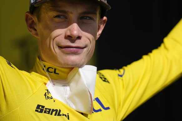 Denmark&#039;s Jonas Vingegaard, wearing the overall leader&#039;s yellow jersey, celebrates on the podium after the thirteenth stage of the Tour de France cycling race over 193 kilometers (119.9 mile ...